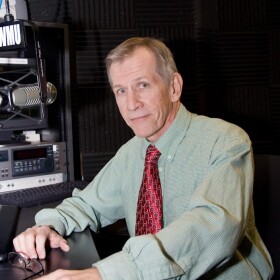 Staff photo of Bob McCabe in the announcer studio in Lucas Hall at UMSL, 2009.