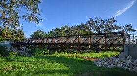 The Pinecraft Pedestrian Bridge stretching across Phillippi Creek.