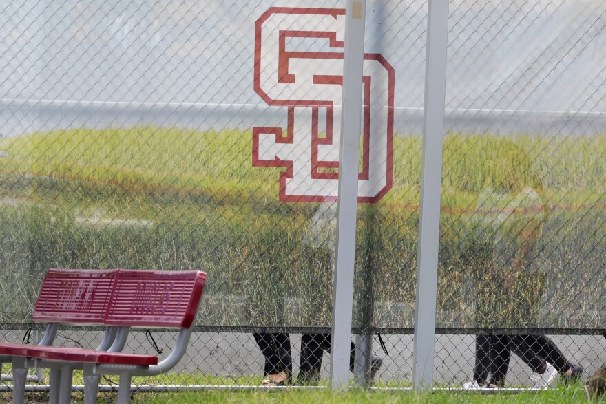 Jurors walk around the Ò1200 building,Ó the crime scene where the 2018 shootings took place, at Marjory Stoneman Douglas High School in Parkland on Thursday, August 4, 2022. This during the penalty phase in the trial of confessed shooter Nikolas Cruz who previously plead guilty to all 17 counts of premeditated murder and 17 counts of attempted murder. Cruz waived his right to be present at the viewing. (Amy Beth Bennett/South Florida Sun Sentinel via AP, Pool)