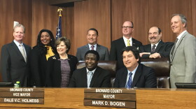 The newly-sworn in Broward County Commission gathers around Mark Bogen after he is unanimously voted county mayor Tuesday. 