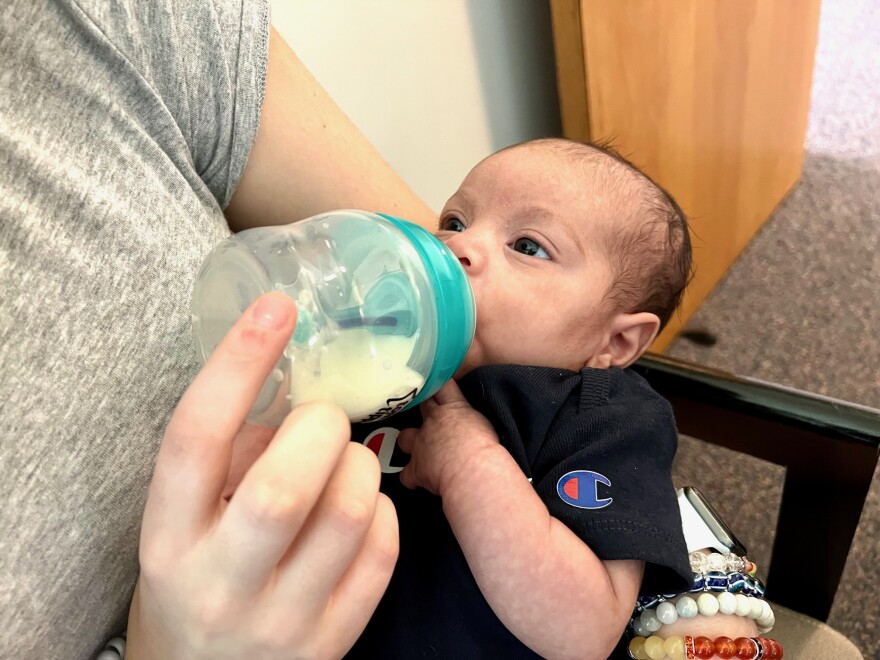 Selena Howington feeds her baby, Aliyah. The first-time mother has her family helping her keep baby formula in stock.