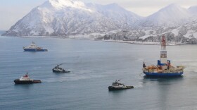 The Aiviq (blue hull) escorts the tugs Corbin Foss, Ocean Wave and Lauren Foss as they tow the conical drilling unit Kulluk from Kiliuda Bay near Kodiak Island, Alaska, Feb. 26, 2013.