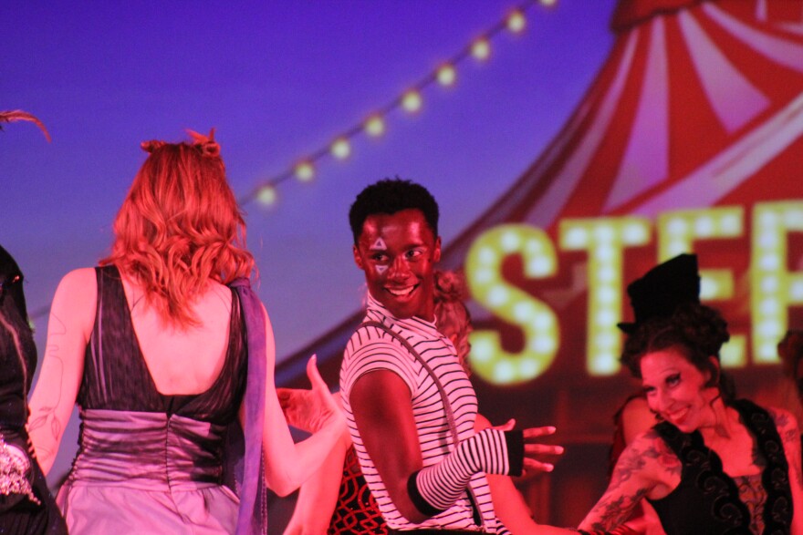 Sam Stableford dances with the other carnival characters during an opening song at the Carbondale Fashion Show on Thursday, March 12, 2026.