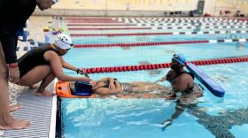 Evolutionary Aquatics swimmers practice using a spine board to remove a potential causality from the pool.