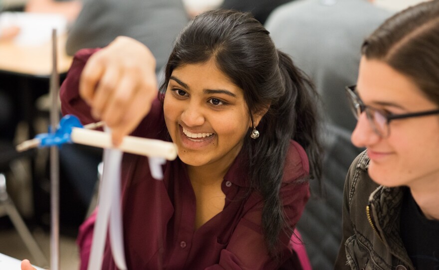 Students Geya Kairamkonda (left) and Patrick Murphy perform an experiment on electric charge using Scotch tape during a physics tutorial session. Their class uses learning assistants as tutors.