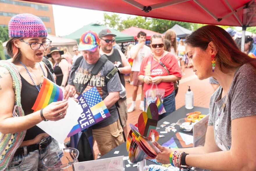 Michelle Rundle (right) with Bethany Christian Church, hands out fans and snack at River City Pride 2025.