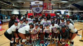 The Delaware State University volleyball team celebrates after winning the MEAC championship.