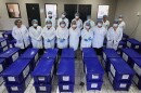 Archivists pose for a group photo with boxes containing testimonies from victims of the internal armed conflict between 1960 and 1996, who sought reparations for the abuses they suffered, in Guatemala City, Wednesday, July 22, 2026.