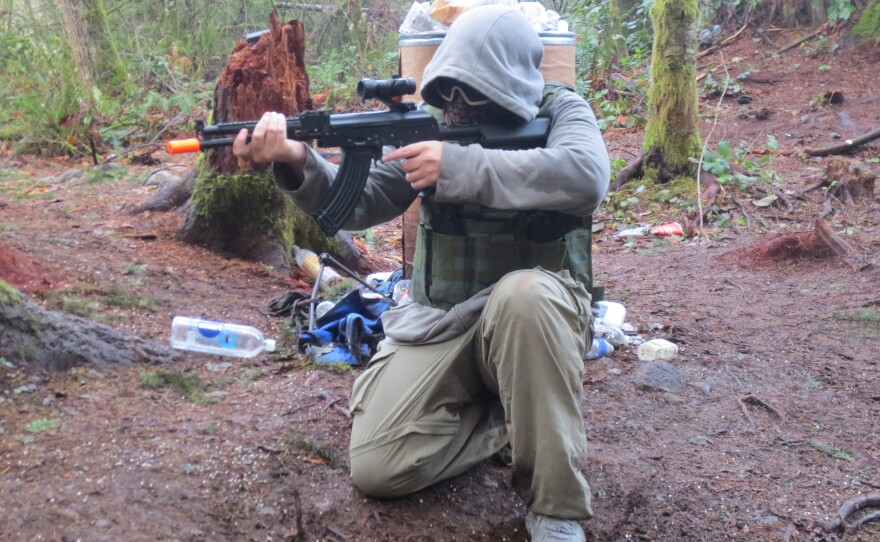 Nathan Boss, 16, poses with his Airsoft gun before playing the game for the first time. Airsoft guns are sold with orange tips to make them look less realistic, but most players remove them.