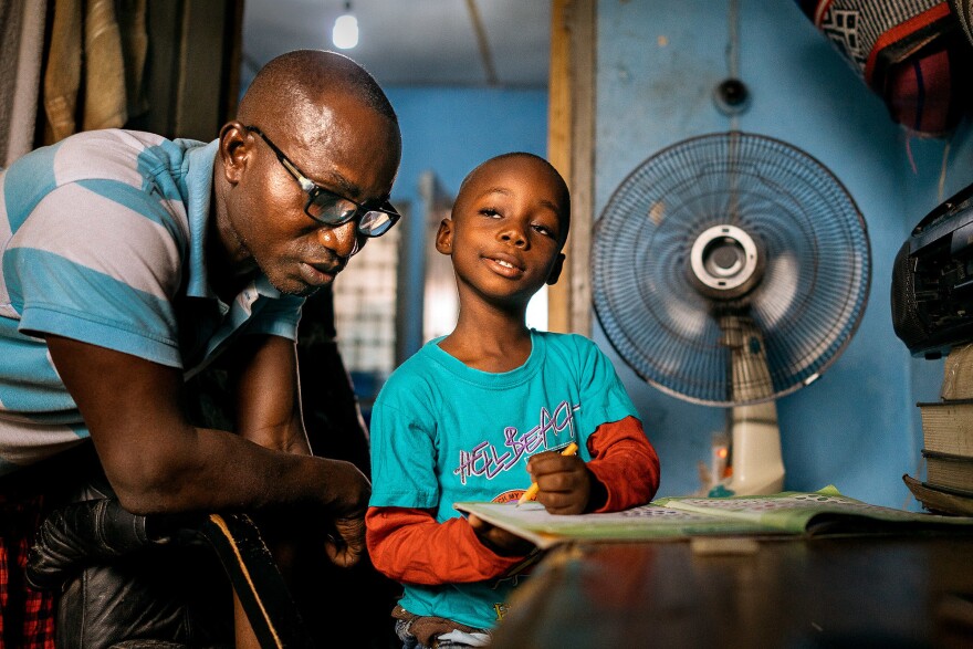 It's their nightly ritual: Herman Agbavor sits down with his 5-year-old son, Herbert, to go over his homework.