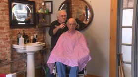 Barber Dan Fleener cuts Morgan County Commissioner Kenny Hale's hair at his shop in Martinsville.