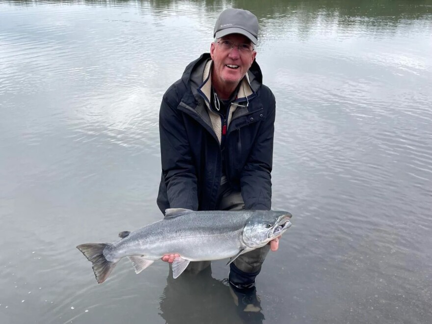 Rick Enstrom poses for a celebratory photo with the silver salmon he caught during a fishing trips to Cordova, Alaska. Enstrom, who ran the Front Range retail operations of his family’s business — Enstrom Candies — until 2022, is still recovering from West Nile virus. After being bit by a mosquito nearly one year ago, Enstrom is still partially paralyzed as he continues to recover in Denver.