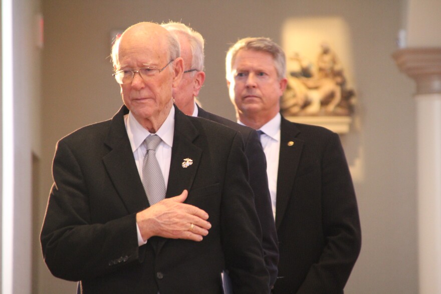 Former U.S. Senator Pat Roberts watches as Dole's casket is carried passed him during the memorial service in Russell. 