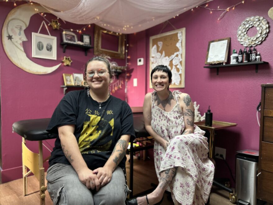 Artist Morganne Davis, left, and artist/owner Kelsea Meadows sitting down in a room.