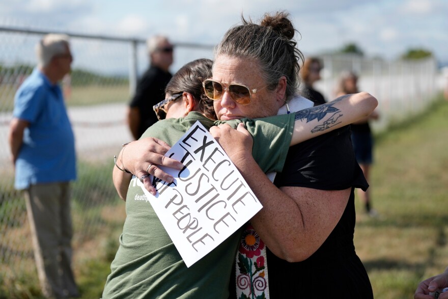 FILE - India Pungarcher, left, hugs Rev. Ingrid McIntyre as demonstrators gather in the area reserved for anti-death penalty protesters outside Riverbend Maximum Security Institution before the execution of Byron Black in Nashville, Tenn., on Tuesday, Aug. 5, 2025.