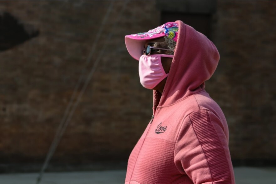 Brenda Lee Elkins-Wylie stands on the sidewalk near the home she rents in Cleveland’s Slavic Village neighborhood with her cat and two dogs. [H.L. Comeriato/Ideastream Public Media]