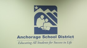 The Anchorage School District logo on the wall of the school board chambers