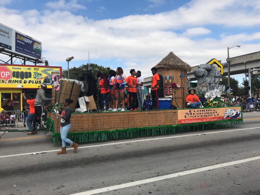 Onlookers watched festive floats go down the procession.