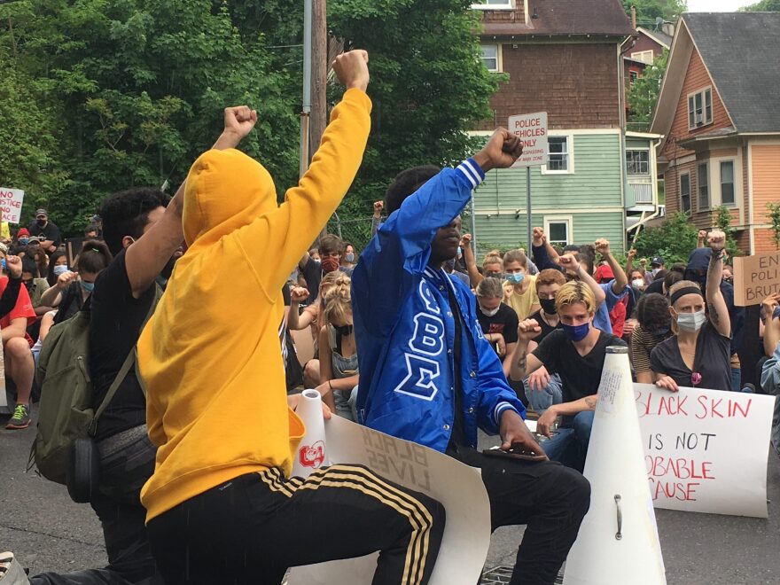 Protesters outside the Ithaca Police Department kneeling for 8 minutes 45 seconds during a protest against police brutality and the killing of George Floyd. June 3, 2020 (Celia Clarke/WSKG Public Radio)