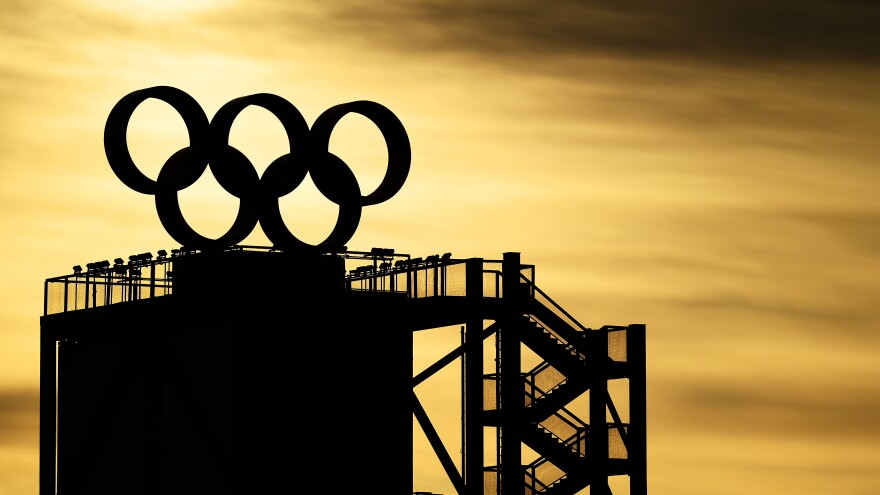 The Olympic Rings logo is seen on the top of a tower as the sun rises on Feb. 7, 2022 at the Beijing Winter Olympics.