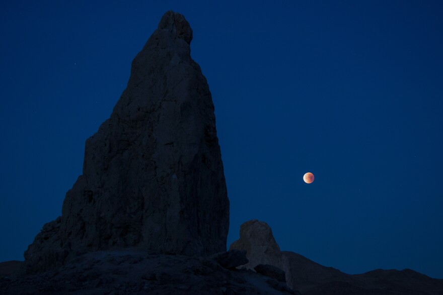 A lunar eclipse viewed from California's Trona Pinnacles Desert National Conservation Area. Scientists believe there may be more moons in the galaxy than planets.