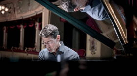 Fred Hersch playing a grand piano