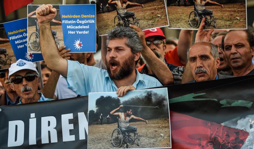 Turkish demonstrators bear signs proclaiming their solidarity with the Palestinians during a rally Tuesday in Istanbul. Turkey's leftist opposition party called the demonstration to protest the killing, the day before, of dozens of Palestinians during clashes with Israeli security forces.
