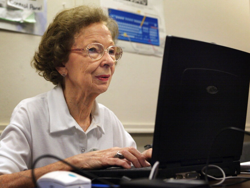 77-year-old Suzette D'Hooghe works on her laptop computer during a computer class in Des Plaines, Ill., in 2003. Increasing numbers of people older than 50 are turning to social networking to share updates and connect with family and friends.