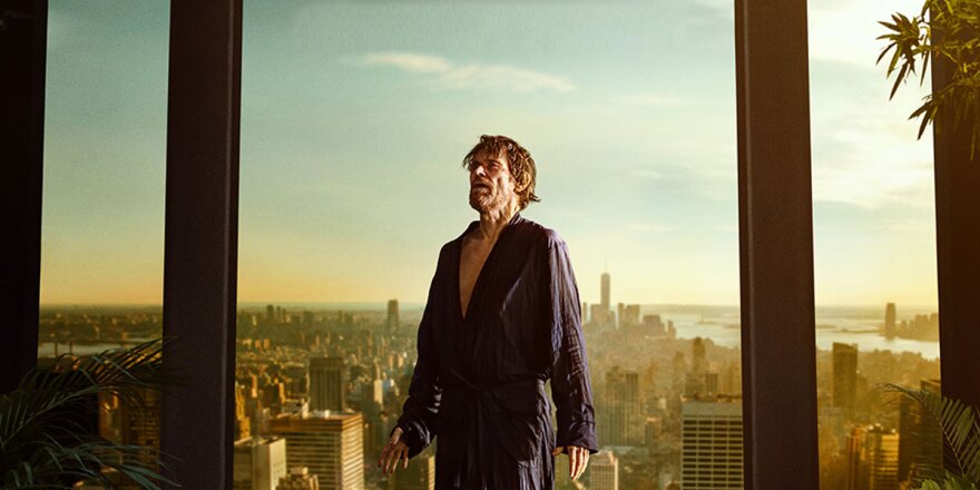 Willem Dafoe pictured in a luxury penthouse on an upper story