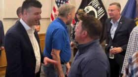 Seventh District Congressman Tom Barrett (far left) and U.S. Secretary of Veterans Affairs Doug Collins (far right) in Howell speaking with event attendees.