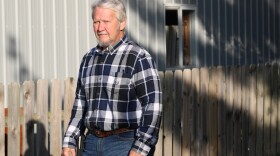 Brian Daggy stands at the fence along his property in Boone County
