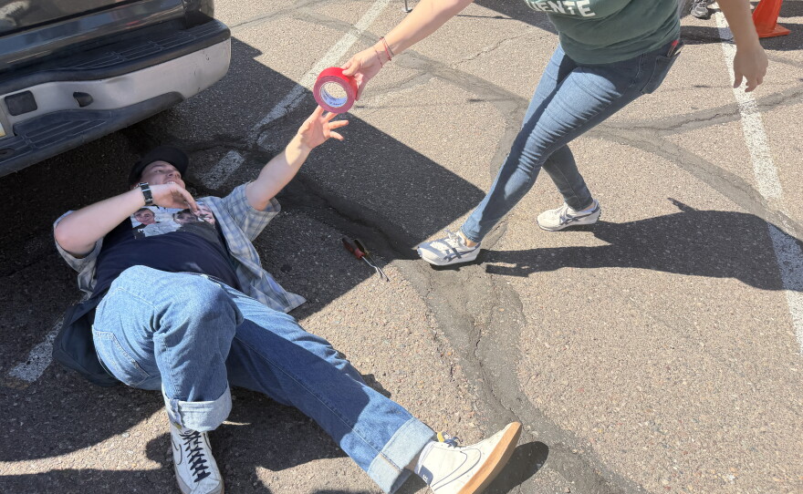 Volunteers from Puente repair a broken tail light
