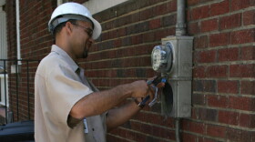 A Duke Energy technician disconnecting electricity at a residence due to nonpayment in North Carolina, 2008.