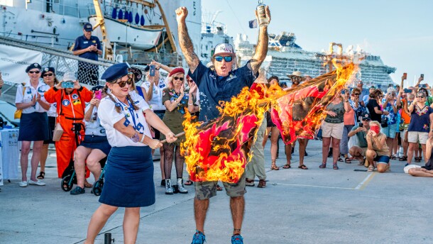 Paul Menta, Conch Republic Speaker of the House and Administrator of Rum, lifts his hands in celebration as hurricane warning flags go up in flames Saturday evening, Nov. 30 at Key West's Truman Waterfront. The rum-soaked tradition marks the official end of the 2025 Atlantic hurricane season.