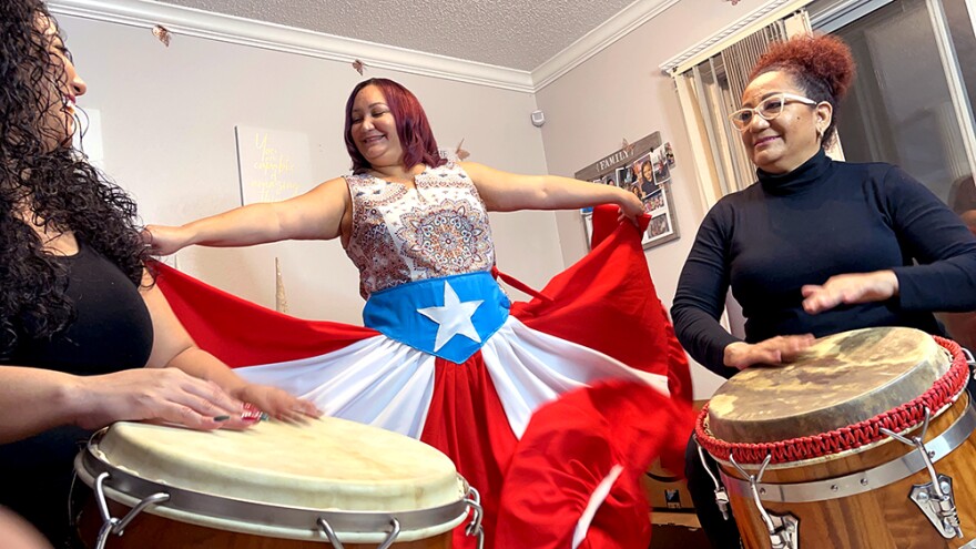 Barbara Liz-Cepeda (center) performs with her sister Caridad Cepeda (left) and their mother Tata Cepeda (right) who are visiting from Puerto Rico. All three women are involved with promoting Bomba and Plena through dance classes and community events. 