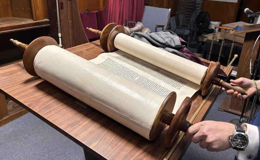 A Torah opened on an altar.