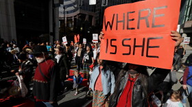 FILE - Dennis Willard, of Bellevue, Wash., carries a sign that reads "Where Is She" as he marches in support of missing and murdered indigenous women during a rally to mark Indigenous Peoples' Day in downtown Seattle, on Oct. 14, 2019. (AP Photo/Ted S. Warren, File)