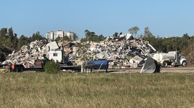 Piles of Hurricane Ian debris form mountains at a debris-management site along U.S. 41 in south Lee County.