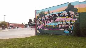 A mural designed by local non-profit Big Car and painted by residents of the Garfield Park neighborhood, on the side of Suding Hardware. Across Shelby street, the former tanning salon where Texas-based non-profit Responsive Education hoped to open a charter school.