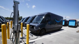 A fleet of Electric Delivery Vehicles (EDV) are seen connected to electric chargers during a launch event between Amazon and Rivian at an Amazon facility on July 21, 2022 in Chicago, Illinois. This unveiling is major milestone towards Amazon's goal of having 100,000 Rivian EDVs on the road by 2030, and Amazon has made a Climate Pledge commitment to reach net-zero carbon by 2040 and has also pledged to guarantee 50% of all shipments reach net zero carbon by 2030.