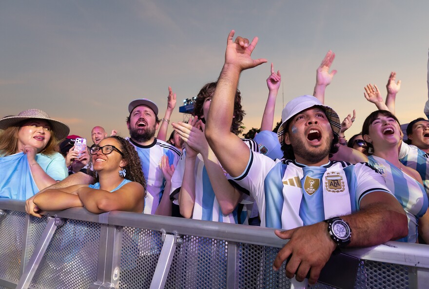 Argentine fans cheer Messi during the first half of Kansas City’s first World Cup matchup between Argentina and Algeria at the FIFA Fan Festival on the lawn of the National World War I Museum and Memorial in Kansas City, Missouri.