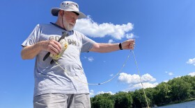 Citizen-scientist Harry Looney tests the waters of Lake Anna.