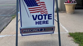 A sign reading "vote here" directs people to Blair Township's Precinct Number 2, on August 2, 2022.