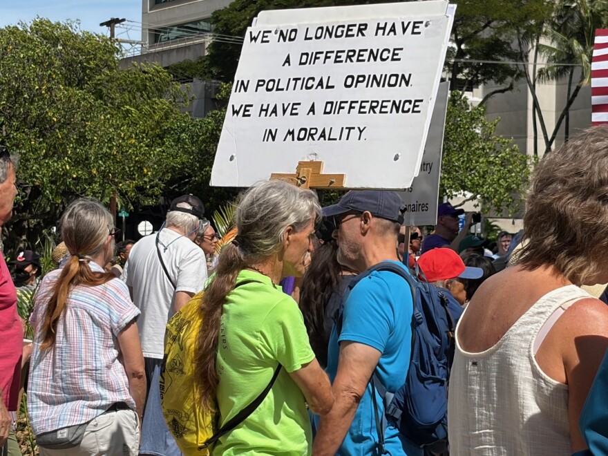 A sign at the "No Dictators" rally reads, "We no longer have a difference in political opinion. We have a difference in morality," in Honolulu on March 28, 2026.