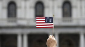 A man holds a flag during an election prayer rally in Albany, N.Y., in August. (Mike Groll/AP)