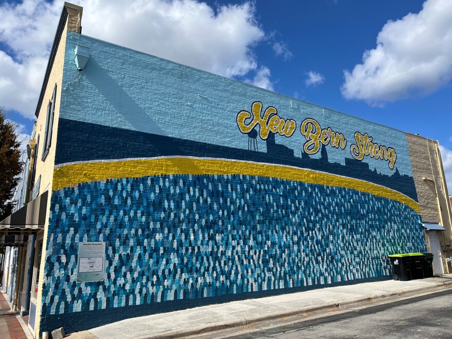 The "New Bern Strong" mural on South Front Street—created just two years ago to honor the community’s resilience after Hurricane Florence—is gone. The property’s new owners, King and Lasso, began covering the artwork this week to make way for a new project.