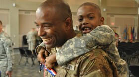 Georgia Army National Guard Capt. Chad Tyson receives a hug from son Chase during a welcome home ceremony for the Georgia National Guard's Agribusiness Development Team III, which returned home to Marietta, Ga., after a 10-month deployment to Afghanistan. Specially trained by the University of Georgia Agricultural Science Department, ADT 3 assisted Afghan farmers in improving crop yield, food storage practices, and water conservation.