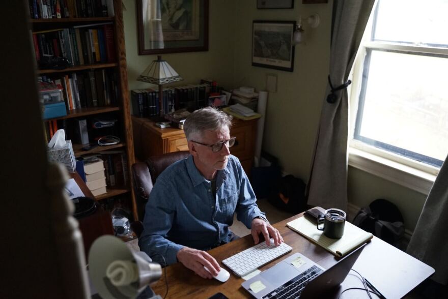 Pittsburgh Post-Gazette photographer Steve Mellon works in his study in his home in Emsworth.