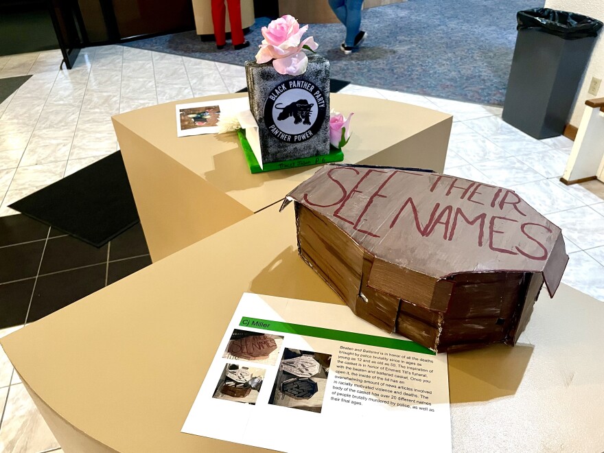 Claire Millers project, inspired by the lynching of 14-year-old Emmett Till, used separate pieces of cardboard stuck together to create a beat up looking casket with 'See Their Names' scrawled across the top.