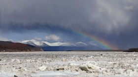 A rainbow frames a view upriver from the community of Aniak on the Kuskokwim River, where a long run of ice was stuck in place on the evening of May 1, 2025.